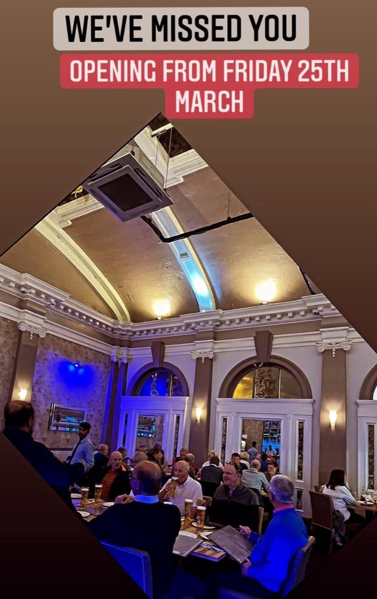 A full dining room under the domed, lit ceiling
